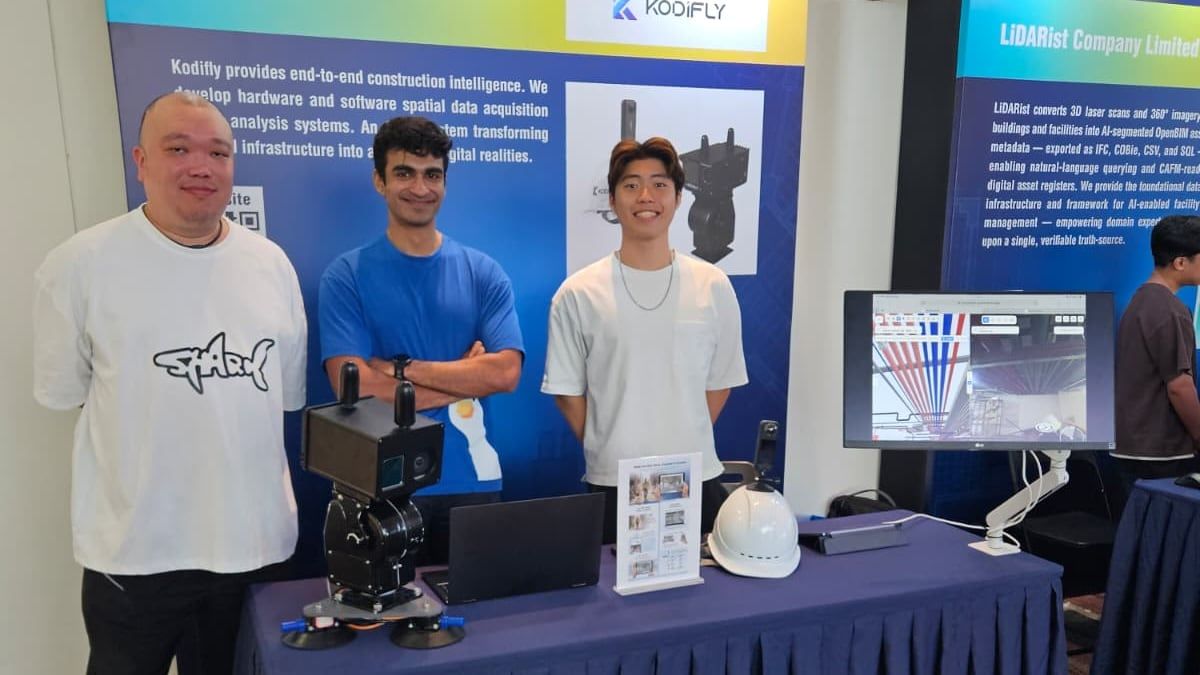 The Kodifly booth at YOUTH Got Open BIM, with a LiDAR unit, a laptop and a helmet camera on the table