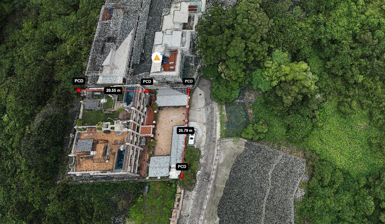 A point cloud of a hillside site with two distances measured on screen